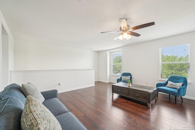 living room featuring baseboards, a ceiling fan, and wood finished floors