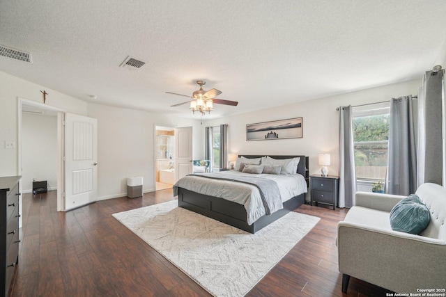 bedroom featuring a textured ceiling, visible vents, and dark wood-style flooring
