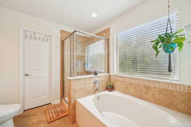 full bathroom with a bath, a shower stall, toilet, and tile patterned floors
