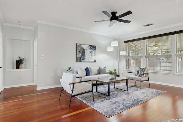 living room featuring baseboards, visible vents, a ceiling fan, wood finished floors, and ornamental molding
