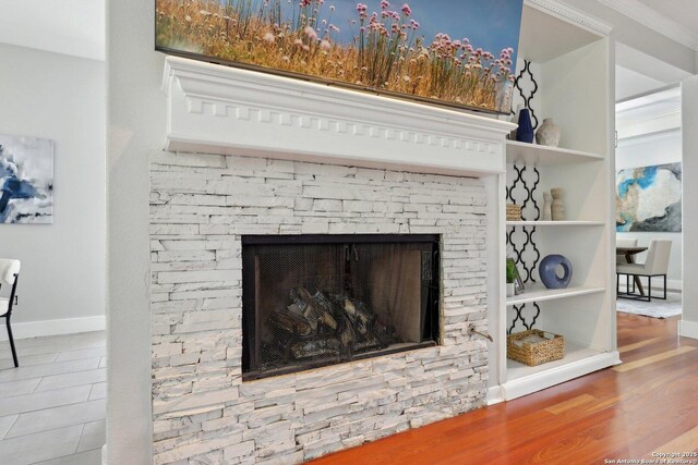 details featuring baseboards and a stone fireplace