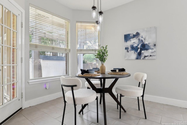 dining room featuring baseboards and light tile patterned floors