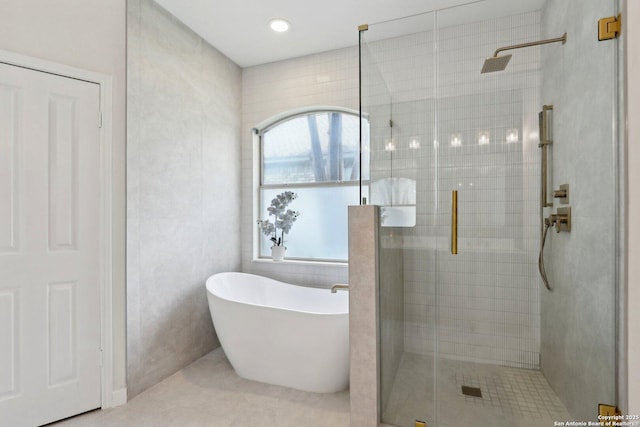 full bath with a soaking tub, tile patterned floors, recessed lighting, and a stall shower