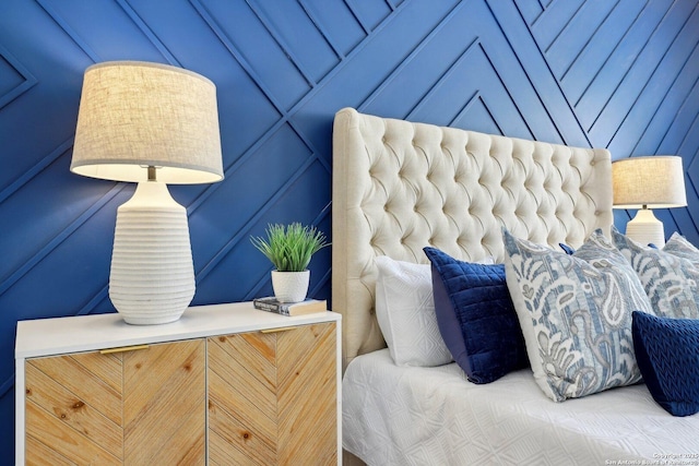 bedroom featuring a decorative wall