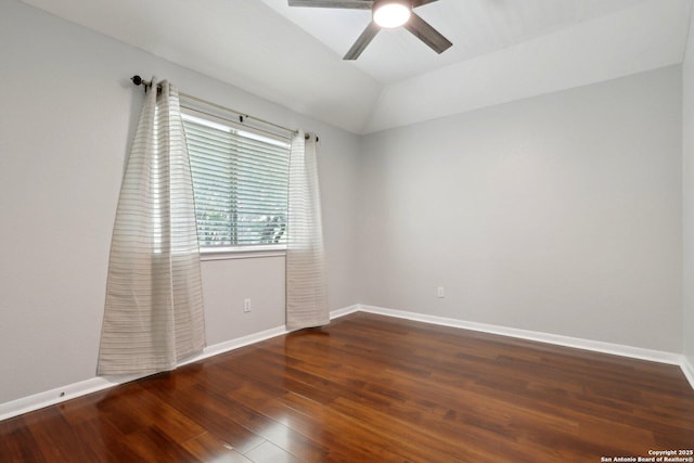 empty room with baseboards, a ceiling fan, wood finished floors, and lofted ceiling