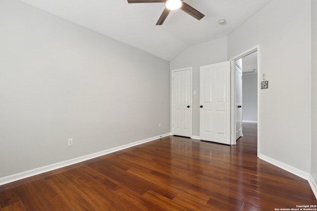 unfurnished bedroom featuring vaulted ceiling, wood finished floors, a closet, ceiling fan, and baseboards