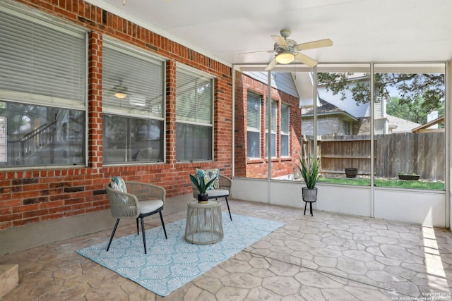 unfurnished sunroom with ceiling fan