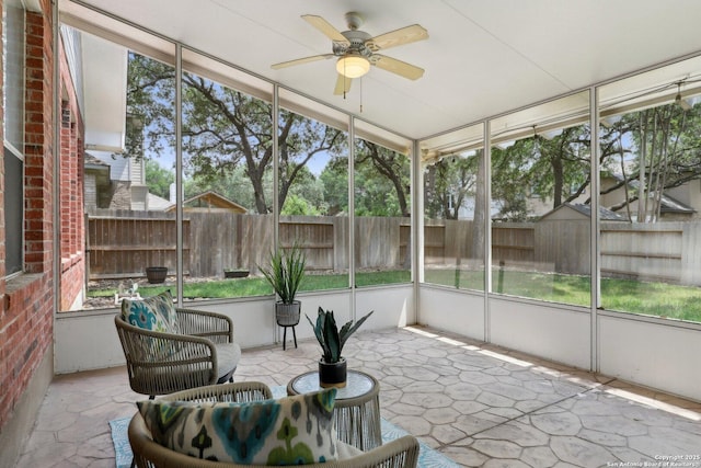 sunroom featuring ceiling fan