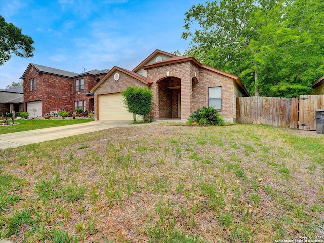 view of front of property featuring concrete driveway, a front lawn, fence, a garage, and brick siding