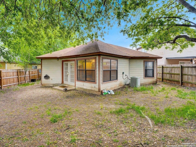 back of property featuring a fenced backyard and french doors