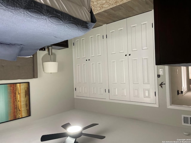 interior space with a ceiling fan and visible vents