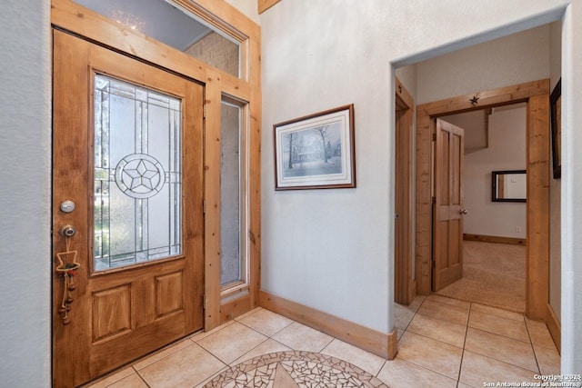 entryway featuring baseboards and light tile patterned floors