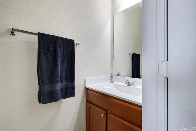 7143 Dulce Mdw, San Antonio, TX 78252 - bathroom with a textured wall and vanity