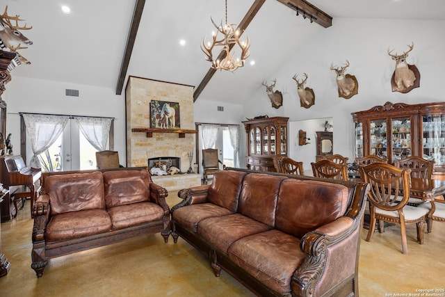 living room featuring an inviting chandelier, visible vents, beamed ceiling, and plenty of natural light