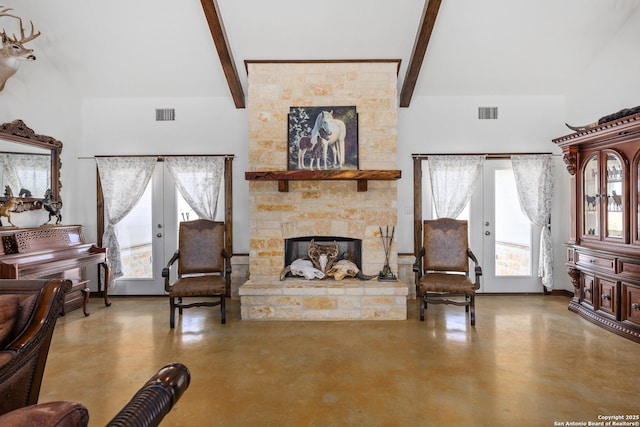 living area with visible vents, a fireplace, french doors, a wealth of natural light, and concrete floors
