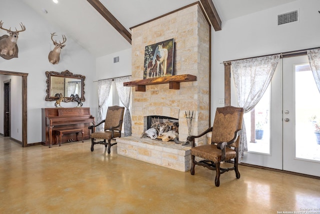living area with high vaulted ceiling, a healthy amount of sunlight, finished concrete floors, and beam ceiling