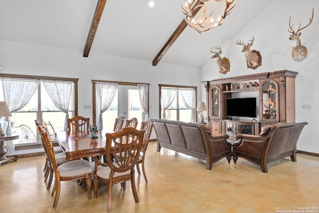 dining room featuring lofted ceiling with beams, an inviting chandelier, and finished concrete floors