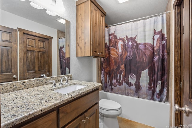 full bath featuring a textured ceiling, toilet, shower / bath combo with shower curtain, a textured wall, and vanity