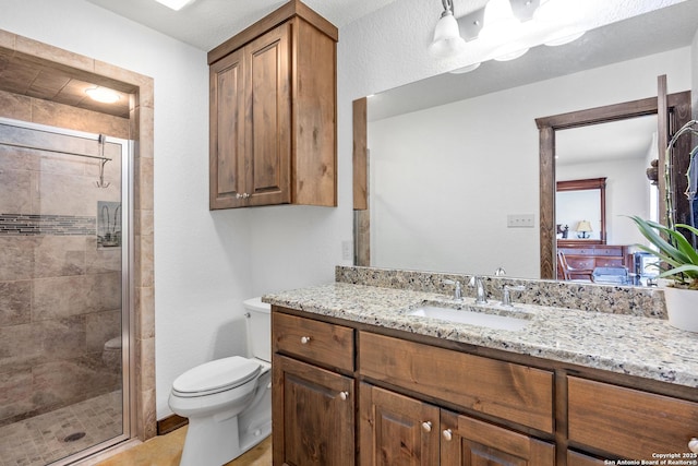 full bathroom with vanity, toilet, and a stall shower