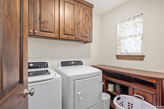 laundry area with washing machine and dryer and cabinet space