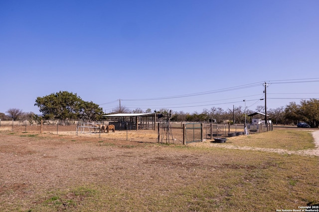 view of yard with an outdoor structure and a rural view