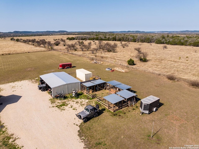 birds eye view of property with view of desert and a rural view