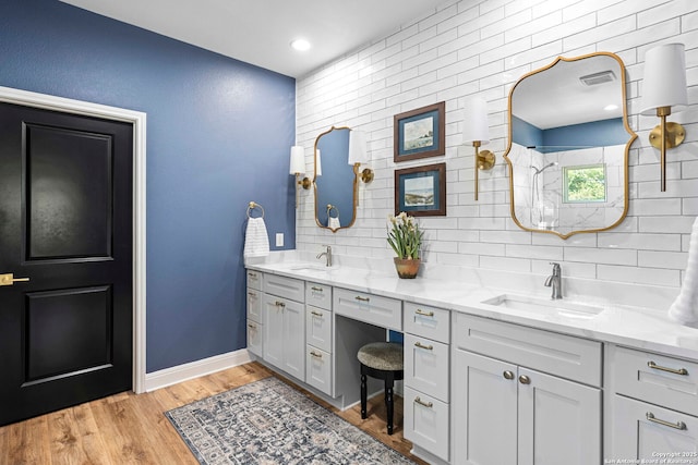 full bathroom with visible vents, a sink, double vanity, and tasteful backsplash