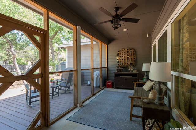 sunroom / solarium with a healthy amount of sunlight and a ceiling fan