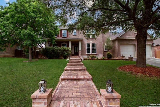 511 Mesa Rdg, San Antonio, TX 78258 - view of front of house with driveway, a front lawn, brick siding, and a garage
