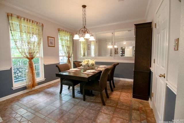 511 Mesa Rdg, San Antonio, TX 78258 - dining space featuring ornamental molding, stone finish flooring, baseboards, and a notable chandelier