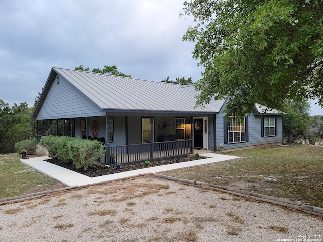 view of front of home featuring metal roof, a standing seam roof, and covered porch