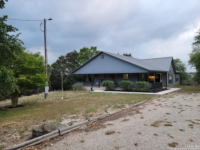 view of front of house with a porch and metal roof
