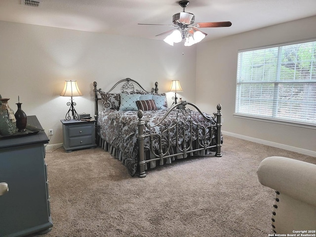 bedroom featuring visible vents, a ceiling fan, baseboards, and carpet