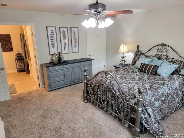 bedroom with ceiling fan, light carpet, and visible vents