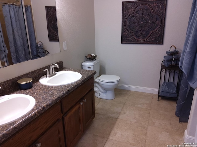 full bath with baseboards, a sink, double vanity, and toilet