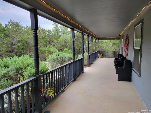 exterior space with a view of trees and covered porch