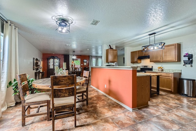 5402 Palamon Farm, San Antonio, TX 78228 - kitchen featuring a textured ceiling, brown cabinetry, visible vents, and under cabinet range hood