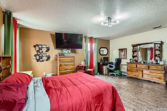 5402 Palamon Farm, San Antonio, TX 78228 - bedroom featuring a textured ceiling, wood finished floors, visible vents, and a textured wall