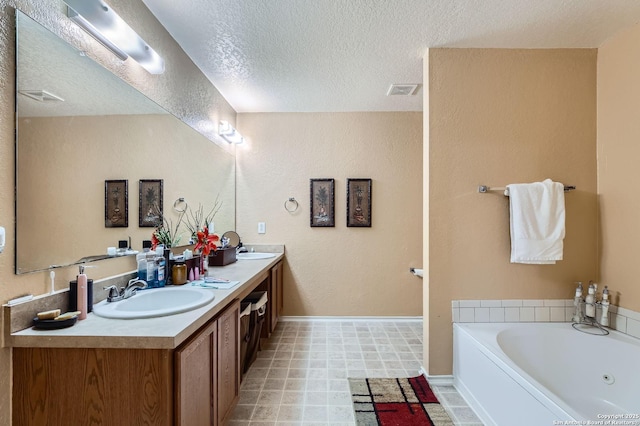 5402 Palamon Farm, San Antonio, TX 78228 - bathroom featuring double vanity, a sink, a bath, baseboards, and a textured ceiling