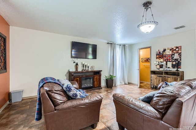 5402 Palamon Farm, San Antonio, TX 78228 - living area featuring a glass covered fireplace, visible vents, and baseboards