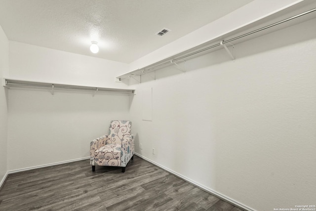 walk in closet featuring wood finished floors and visible vents