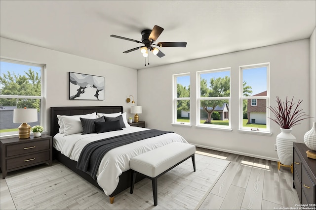 bedroom with light wood-type flooring and a ceiling fan