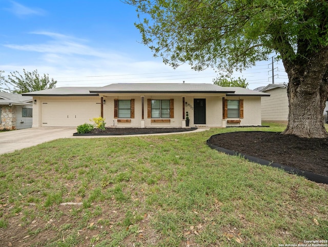 single story home with concrete driveway, a front lawn, a porch, a garage, and brick siding
