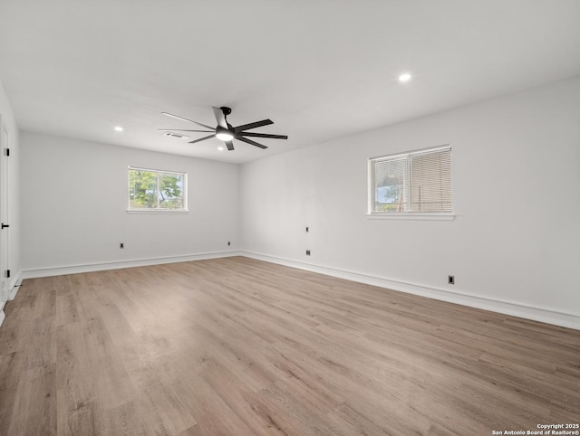 unfurnished room featuring recessed lighting, light wood-style floors, a ceiling fan, and baseboards
