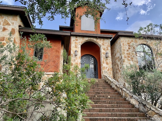 doorway to property with stone siding