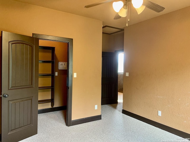 unfurnished bedroom with a ceiling fan and baseboards