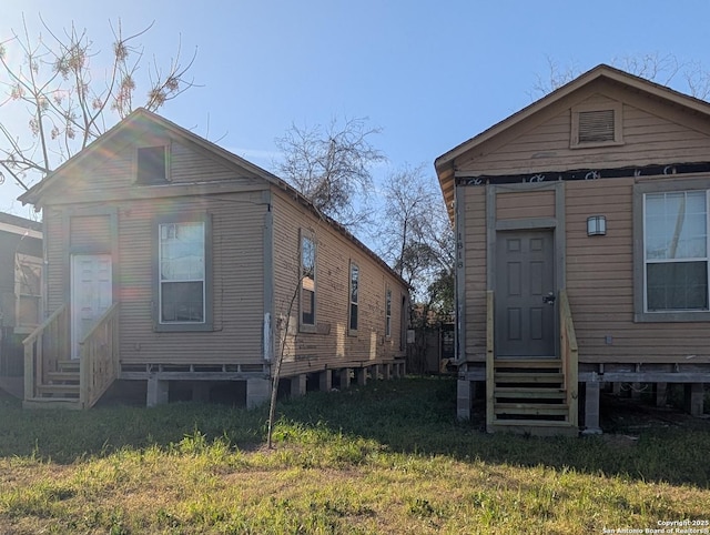 rear view of house featuring entry steps