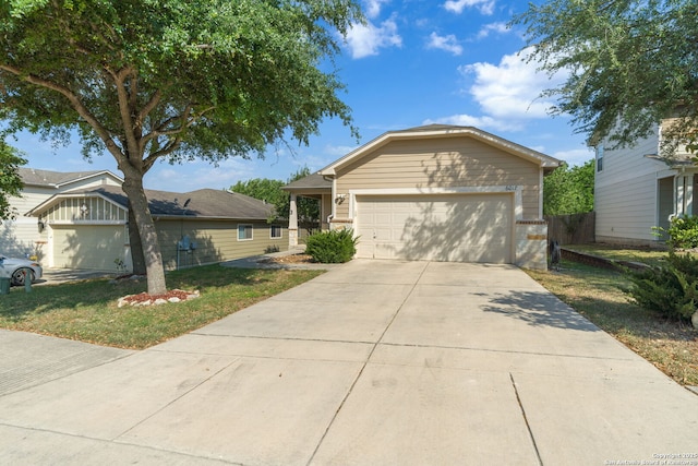 ranch-style house with an attached garage, a front lawn, and concrete driveway