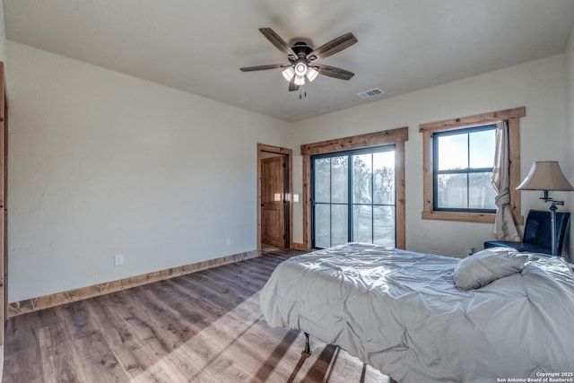 841 Postert, Floresville, TX 78114 - bedroom with baseboards, visible vents, wood finished floors, access to outside, and ceiling fan