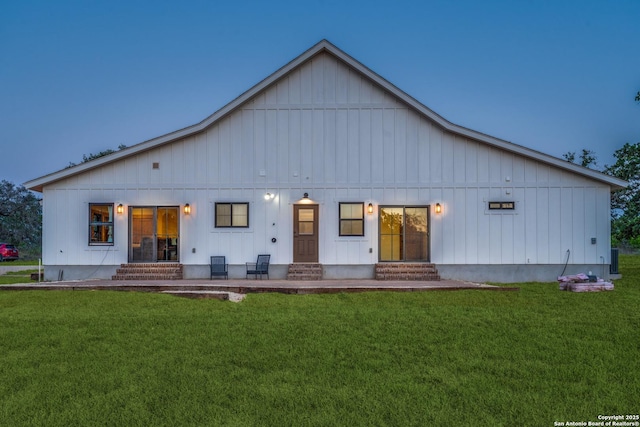 841 Postert, Floresville, TX 78114 - rear view of property featuring board and batten siding, entry steps, and a yard